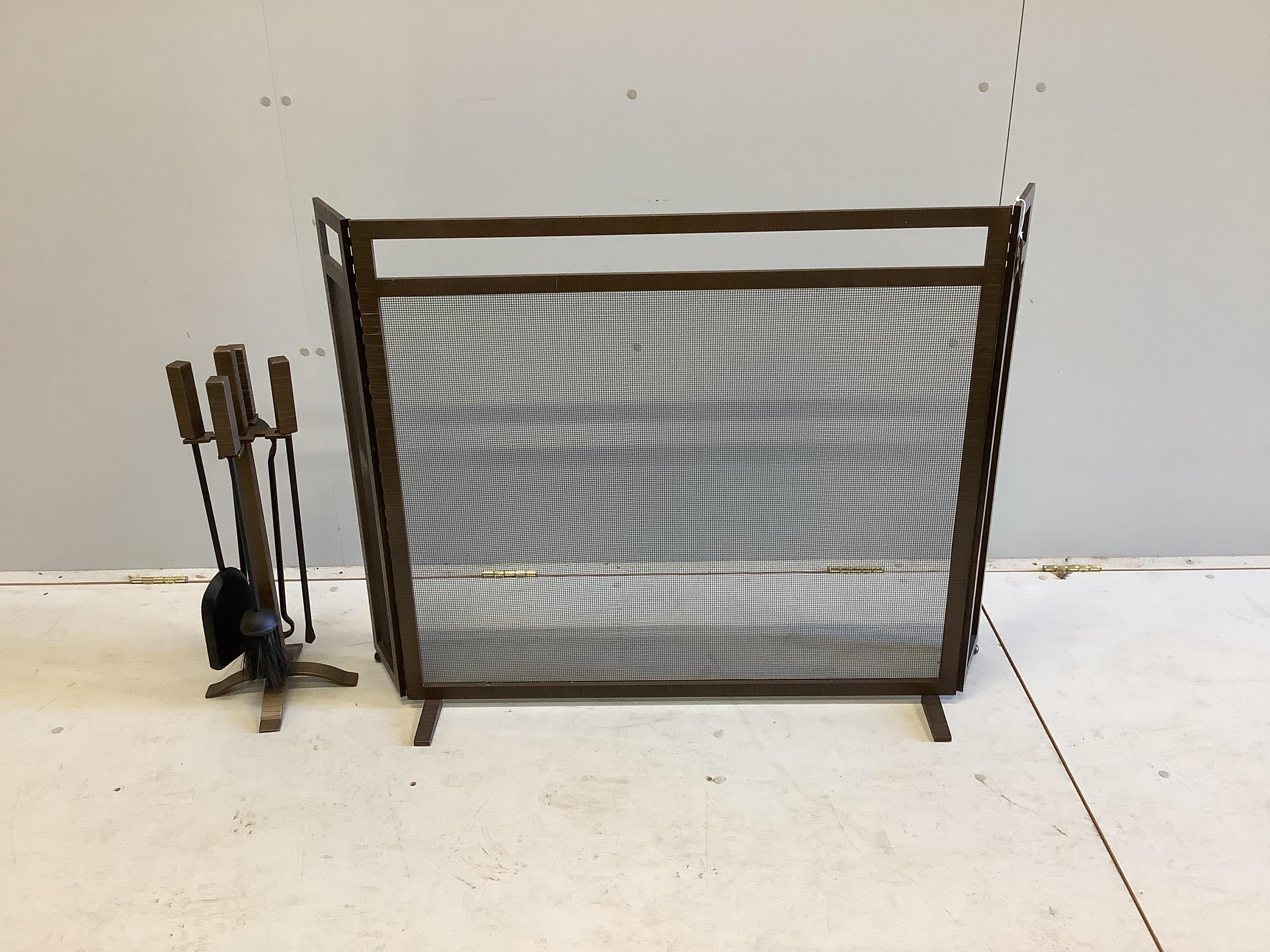 A spark guard, minimum width 90cm, depth 18cm, height 80cm and fire irons in antique distressed brass by Forgeability